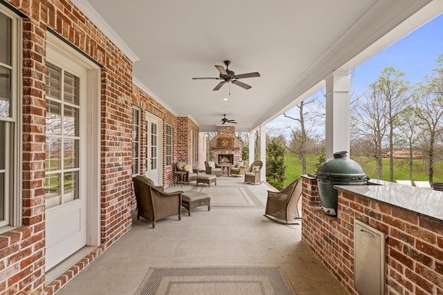 view of terrace with ceiling fan and grilling area