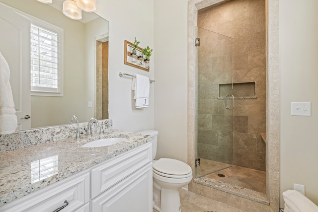 bathroom with toilet, vanity, an enclosed shower, and tile floors