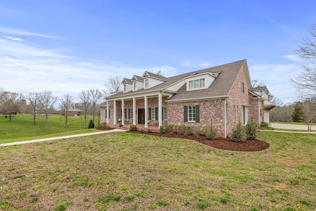 cape cod-style house with covered porch and a front lawn