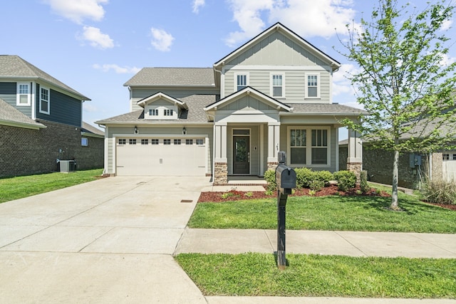 craftsman house featuring a front lawn, central AC unit, and a garage