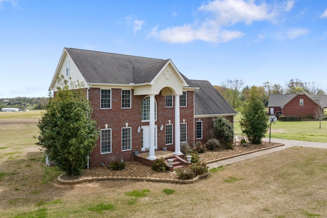 colonial home with a front yard