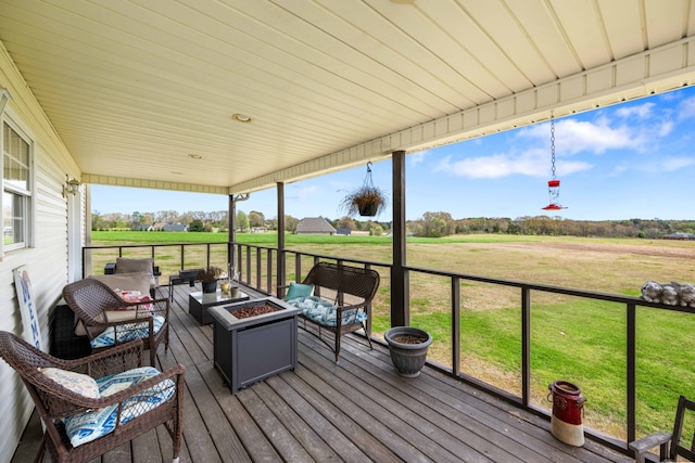 deck with an outdoor living space and a yard