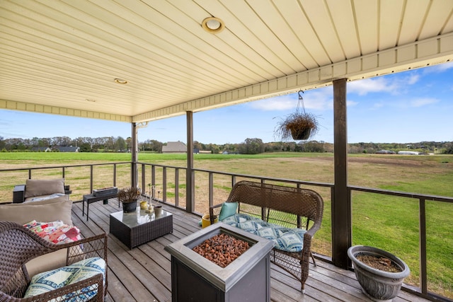 wooden terrace with a yard and an outdoor living space with a fire pit