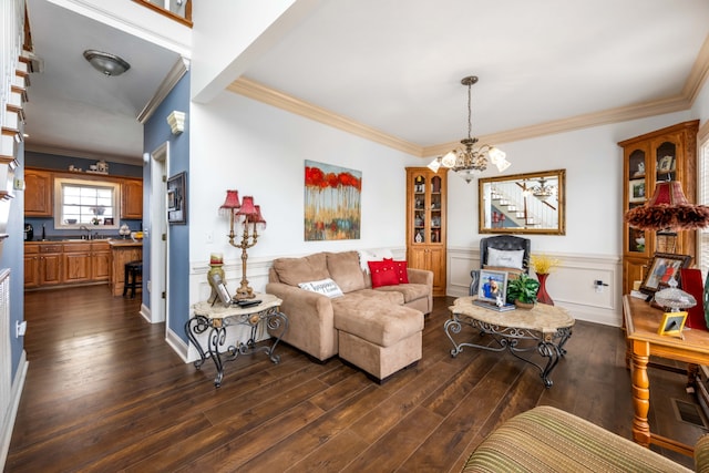 living room featuring ornamental molding, dark hardwood / wood-style flooring, and a chandelier