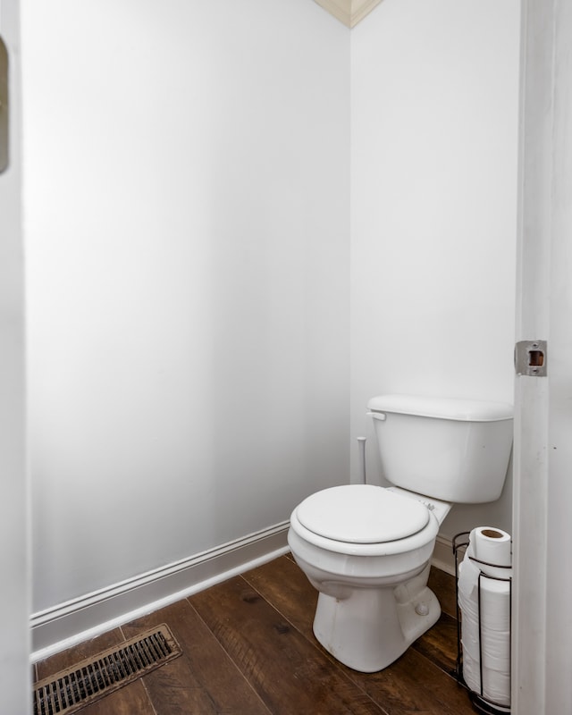 bathroom with toilet and wood-type flooring