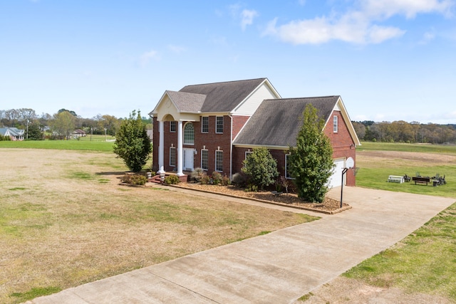 view of front of home featuring a front yard and a garage