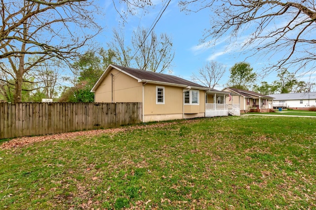 view of side of property with a yard and a porch