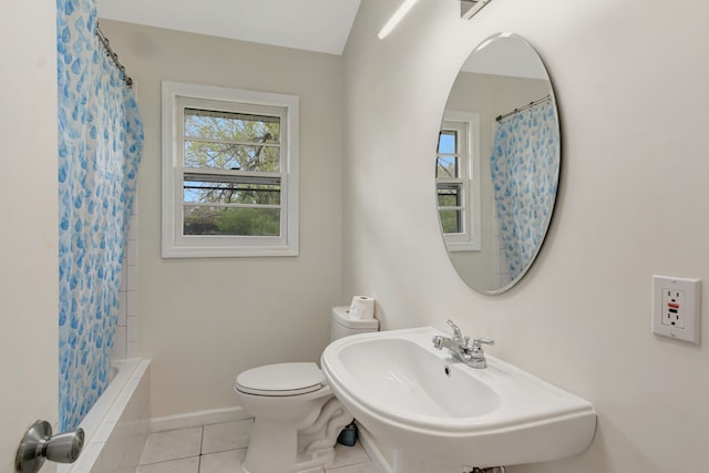 full bathroom with toilet, shower / bath combo with shower curtain, sink, and tile patterned flooring