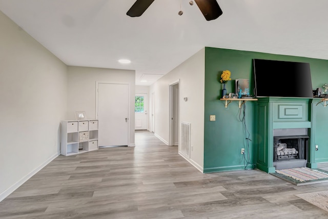 unfurnished living room featuring light hardwood / wood-style floors and ceiling fan