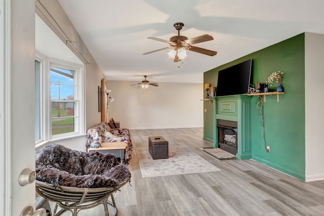 living room featuring light hardwood / wood-style floors and ceiling fan