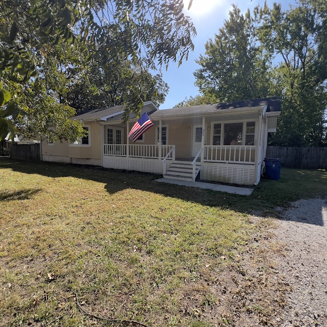 view of front of home featuring a front yard and a porch