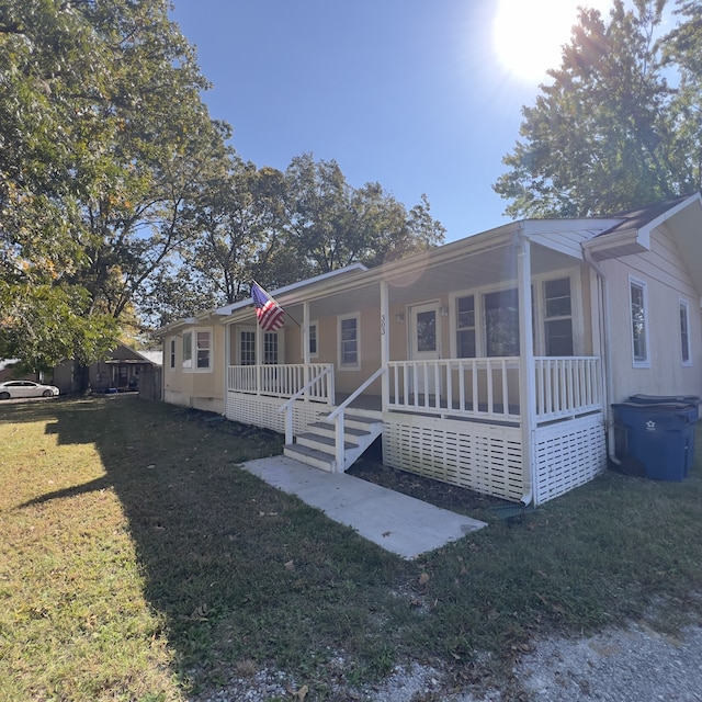 view of front facade with a front lawn and a porch