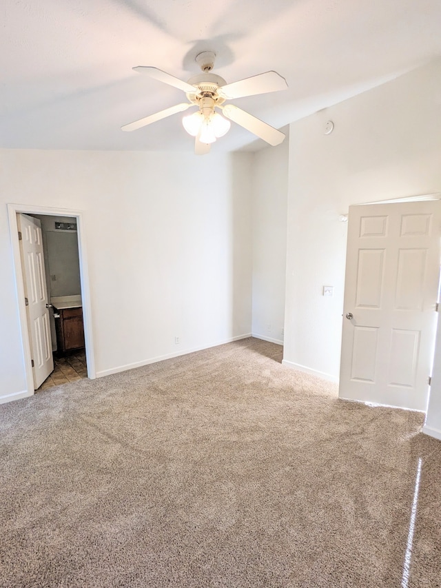 carpeted spare room featuring ceiling fan