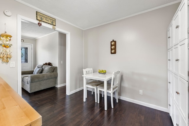 dining area with a textured ceiling, dark wood-type flooring, and crown molding