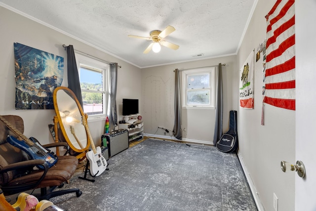 living area featuring ornamental molding, ceiling fan, and a textured ceiling