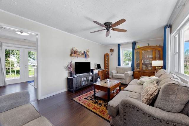 living room with crown molding, dark hardwood / wood-style flooring, ceiling fan, and a textured ceiling