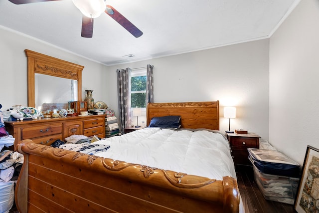 bedroom with hardwood / wood-style floors, ceiling fan, and crown molding