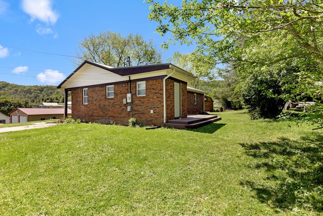 view of side of property with a lawn