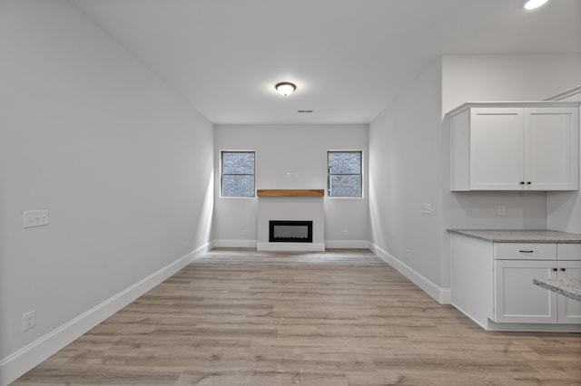 unfurnished living room featuring light wood-type flooring