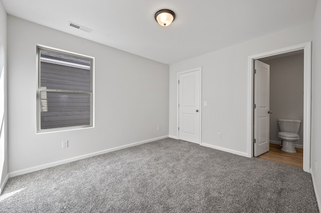 unfurnished bedroom with carpet and ensuite bathroom