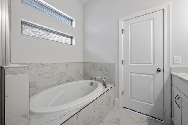 bathroom with vanity and tiled bath