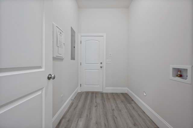 laundry area with electric panel, light hardwood / wood-style floors, and hookup for a washing machine