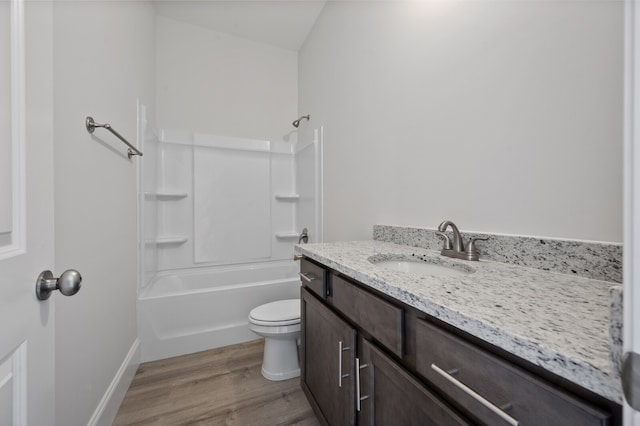 full bathroom with washtub / shower combination, hardwood / wood-style flooring, vanity, and toilet