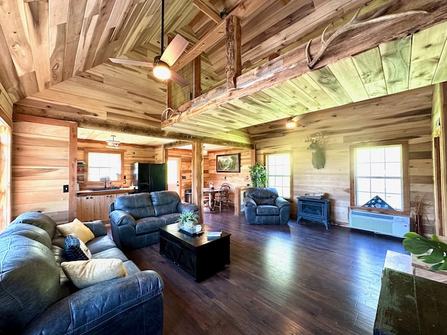 living room featuring dark hardwood / wood-style flooring, plenty of natural light, wooden walls, and wood ceiling