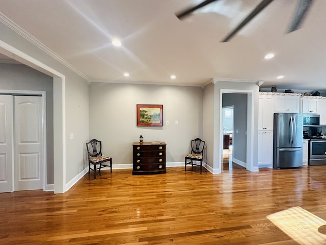 unfurnished room with light hardwood / wood-style flooring and ornamental molding