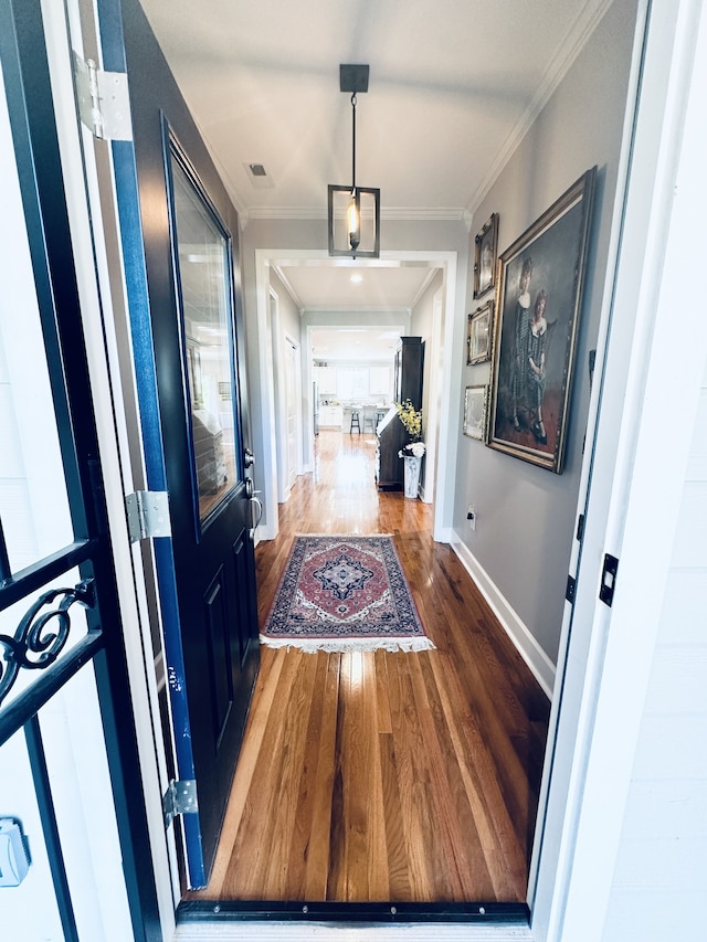 hallway featuring dark hardwood / wood-style floors and ornamental molding