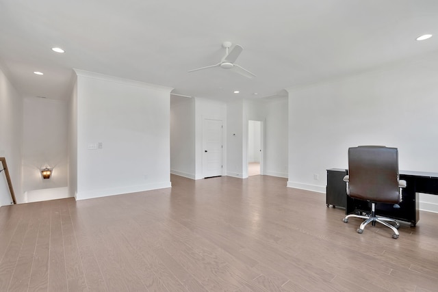 office area with ceiling fan, crown molding, and light wood-type flooring