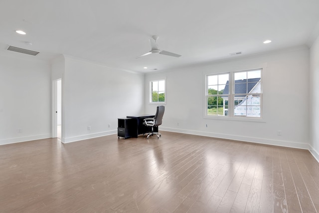 unfurnished office featuring hardwood / wood-style floors, ceiling fan, and ornamental molding