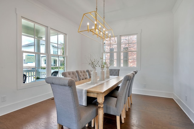 dining room with dark hardwood / wood-style flooring, a chandelier, and crown molding