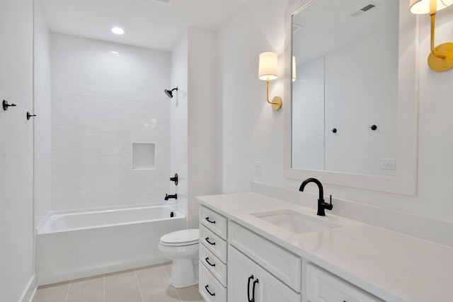 full bathroom featuring tiled shower / bath combo, vanity, tile floors, and toilet