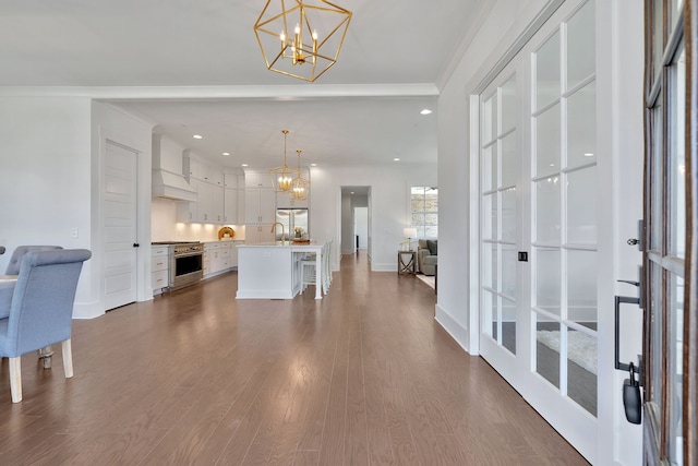 foyer entrance with dark hardwood / wood-style floors, french doors, crown molding, and a chandelier