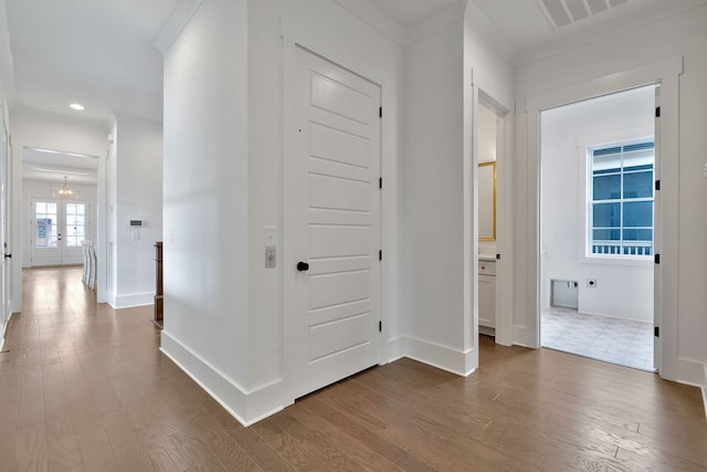 corridor featuring dark hardwood / wood-style flooring and a chandelier