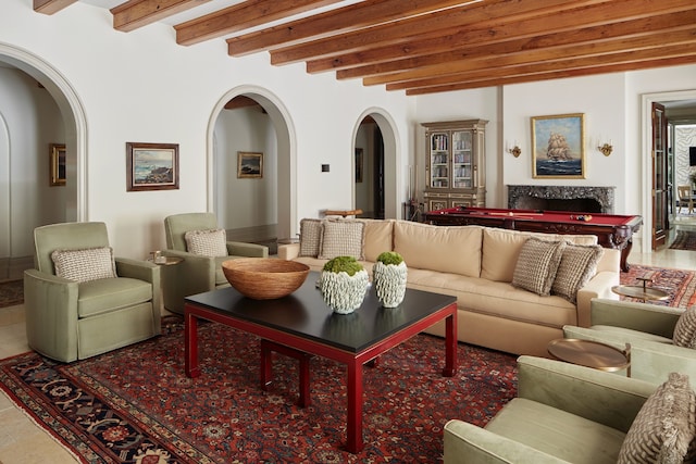 living room featuring beam ceiling and tile floors