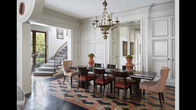 tiled dining room featuring crown molding and a chandelier