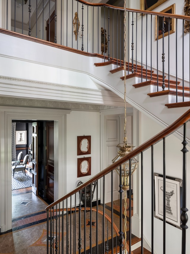 staircase featuring a towering ceiling