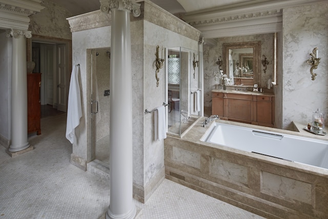 bathroom with vanity with extensive cabinet space, ornate columns, independent shower and bath, and tile flooring