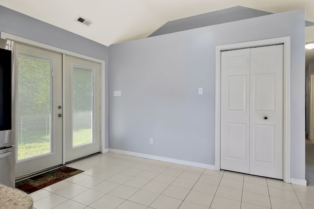 doorway featuring light tile patterned floors and french doors