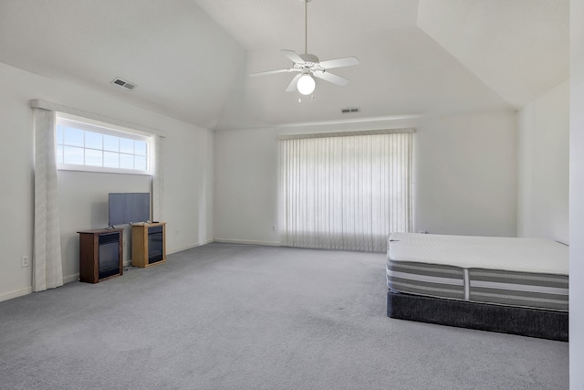 interior space with ceiling fan, carpet flooring, and vaulted ceiling