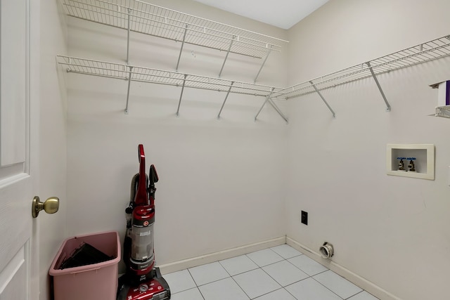 laundry area featuring hookup for an electric dryer, light tile patterned floors, and washer hookup