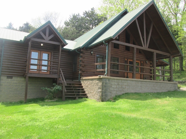 rear view of property featuring a yard