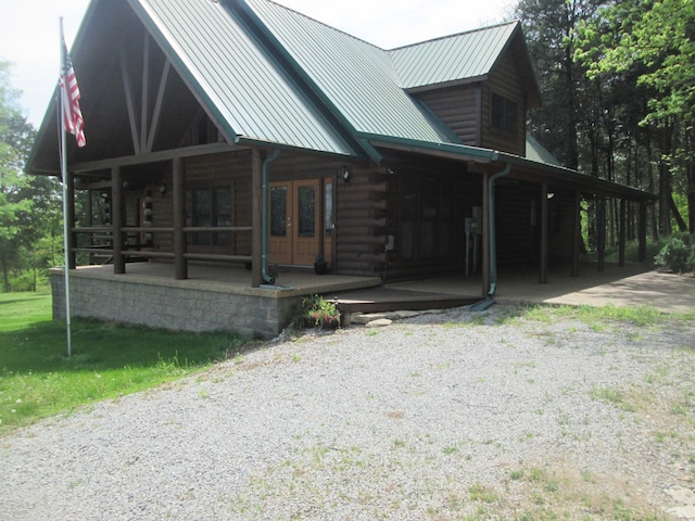 view of side of home with covered porch