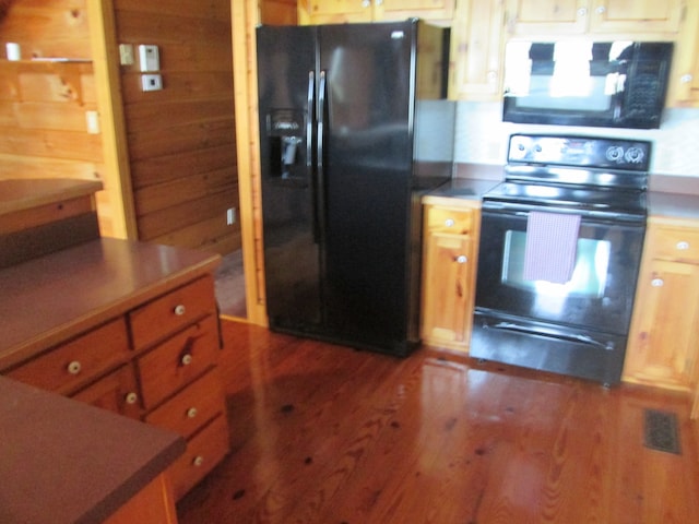 kitchen with wood-type flooring and black appliances