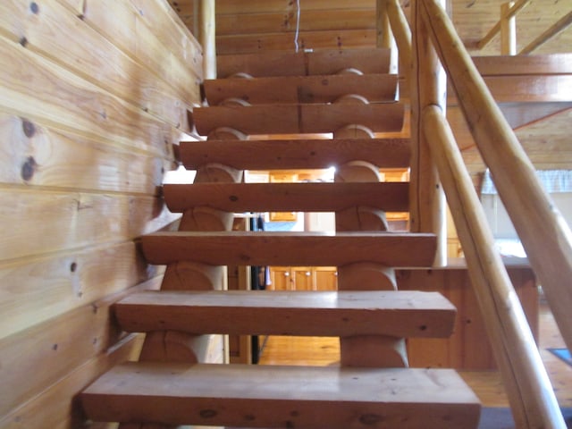 stairs featuring wooden walls