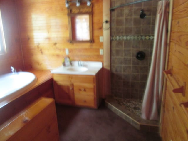 bathroom with curtained shower, wood walls, and vanity