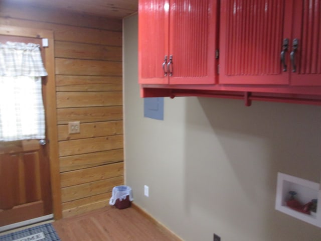 clothes washing area featuring cabinets, hardwood / wood-style flooring, and hookup for a washing machine