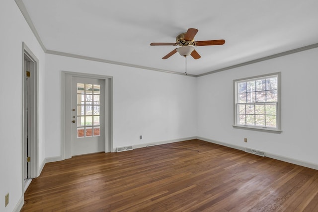 spare room with ceiling fan, ornamental molding, dark hardwood / wood-style flooring, and a healthy amount of sunlight